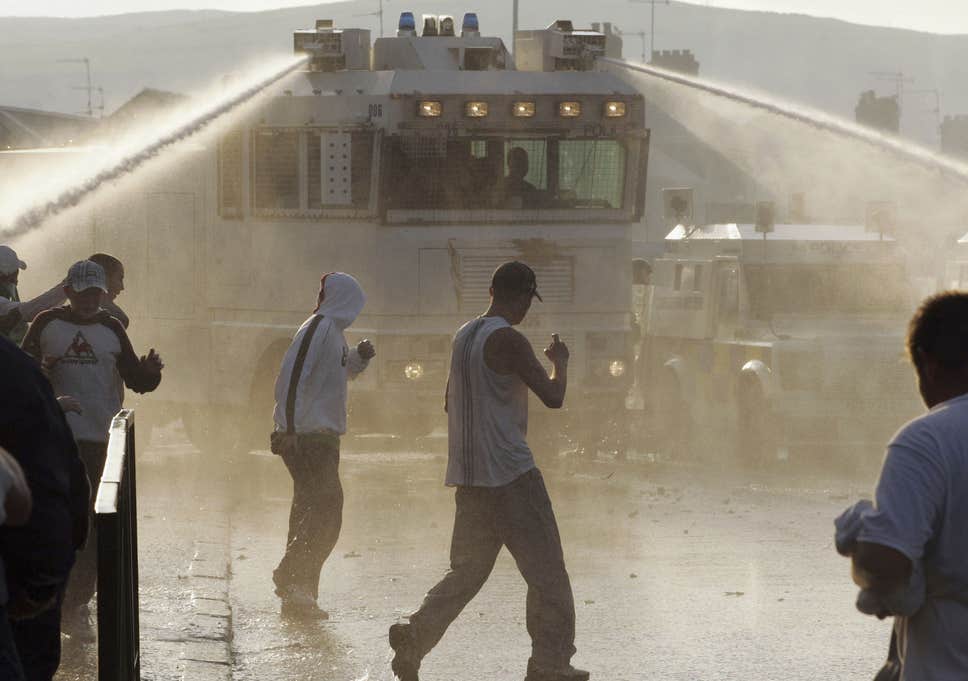 PSNI (Police Service of Northern Ireland) use a water cannon during riots on the Crumlin Road in 2005 in north Belfast